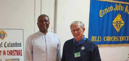 Grand Knight Barry Nicholls (right), Father Titus Egbueh, pastor of St. Martin de Porres Parish and council chaplain, and Bob Williamson of Canon John Burke Council 6217 in Nepean, Ontario, sell Christmas cards at the parish’s Christmas craft bazaar. The Knights participated in the Keep Christ in Christmas program by selling Christmas cards produced by the Order, sponsoring a poster contest at the parish school and displaying a Nativity scene outside the church.