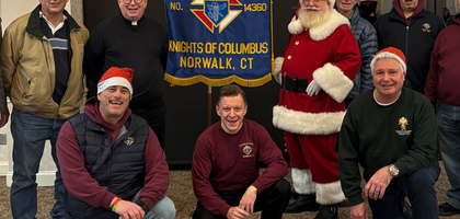 Members of St. Matthew Council 14360 in Norwalk, Conn., gather during the council’s Advent kickoff event at St. Matthew Church. About 180 people attended the event, which included a Nativity scene blessing, tree lighting, visit from Santa, choir music and treats. Parishioners donated about 50 toys for children in need through Toys for Tots.