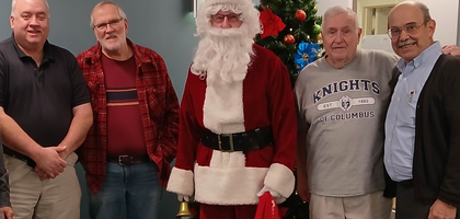 Members of Father Harold M. Wren Council 3963 in Tewksbury, Mass., including brother Knight Paul Hayes dressed as Santa Claus, gather at the New England Pediatric Care Center in North Billerica. The Knights delivered socks to more than 35 patients and candy canes to staff members.