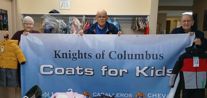 Past State Deputy Richard Doucette (center) and Camille Gallant of Louis Herbert Council 6468 in Moncton, New Brunswick, along with Mary Doucette, president of the council’s associated women’s group, display winter jackets purchased through the Knights of Columbus Coats for Kids program. This past winter season, more than 50 coats and 20 scarves, gloves, winter boots and other items were given to Moncton Headstart for distribution to families in need.