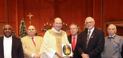 Members of St. Francis of Assisi Council 2555 in Coraopolis, Pa., present an icon of the Sacred Heart of Jesus to Father Frank Kurimsky, pastor of Most Sacred Heart of Jesus Parish and a brother Knight, after a Christmas Mass. The council gifted 1,000 framed images and devotional materials to families after each of the parish’s Christmas Masses. The council contributed $1,300 of the $4,900 project, with the remainder coming from parishioners.