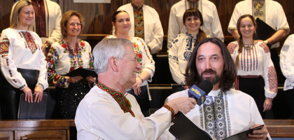 Andrij Lazurko (left), a member of Bishop Budka Council 5914 in Regina, Saskatchewan, interviews Father Vasyl Tymishak, chancellor of the Ukrainian Catholic Eparchy of Saskatoon and a member of Council 5914, during the annual Knights of Columbus Carol Festival fundraiser organized by the Regina  KofC Chapter.