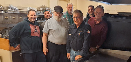 Knights from John Cardinal Dearden Council 744 in Mount Clemens, Mich., gather behind a new kitchen grill purchased for St. Peter Parish with help from the council. 