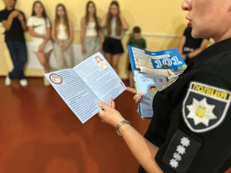 A police officer leads a safety lesson for children.