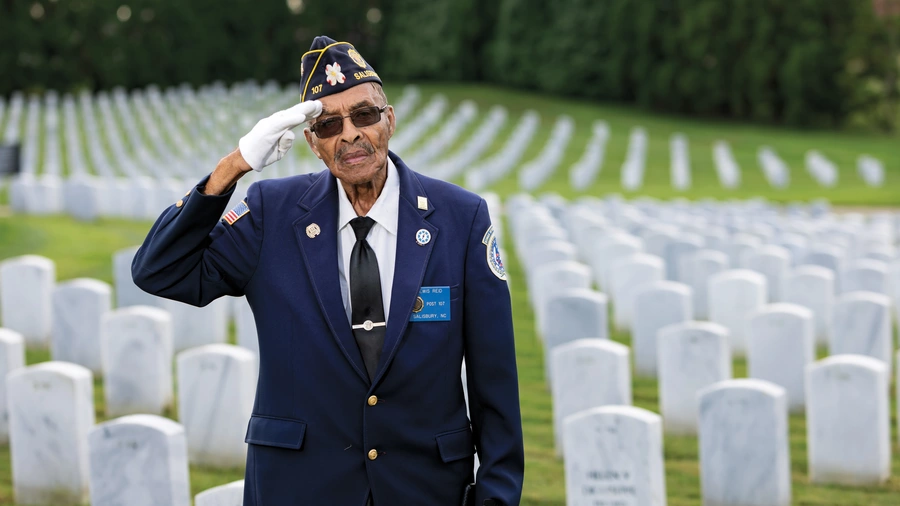 Lewis Reid gives a patriotic salute in Salisbury National Cemetery Annex