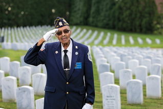 Lewis Reid gives a patriotic salute in Salisbury National Cemetery Annex