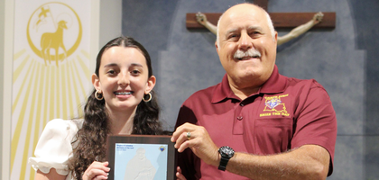 Grand Knight Mike Abbate of Ascension of Our Lord Council 9623 in LaPlace, La., presents seventh-grader Sadie Leblanc with the Father Benjamin Piovan Memorial Scholarship Award.