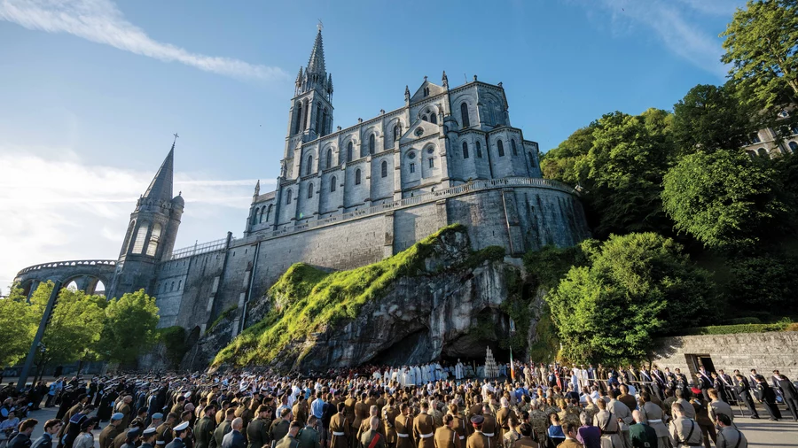Warriors to Lourdes pilgrims and other military personnel gather for Mass at the Grotto beneath the Basilica of Our Lady of the Rosary.