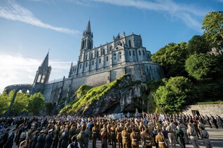Warriors to Lourdes pilgrims and other military personnel gather for Mass at the Grotto beneath the Basilica of Our Lady of the Rosary.