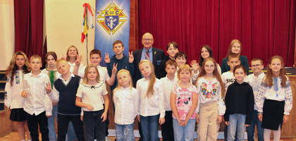 Past Grand Knight Robert Szyman (back row, center) of Father Perez Council 1444 in Chicago gathers with Ukrainian refugee children at the Knights of Columbus Mercy Center at St. Klemens Hofbauer Parish in Warsaw, Poland, after delivering a check for over $3,100 on behalf of the council and Holy Family Assembly 2255. The center is supported by St. Clement Hofbauer Council 17050 and provides after-school and full-day programs for the children. Szyman and other Knights traveling on pilgrimage to Poland were inspired to raise the funds after reading about the Mercy Center’s work in the July/August 2025 issue of Columbia.