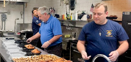 Members of Lyndhurst (N.J.) Council 2396 prepare to serve food during the council’s chicken dinner fundraiser at Our Lady of Mount Carmel Parish.