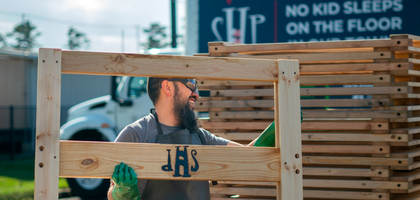 Sergio Castillo, life director of Bishop Nicholas A. Gallagher Council 8482 in Houston, carries part of a frame constructed during a build with Sleep in Heavenly Peace, an organization dedicated to building beds for children without proper sleeping arrangements.