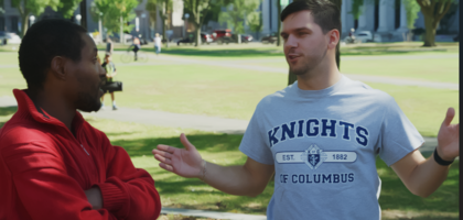 A Knight talks with another man