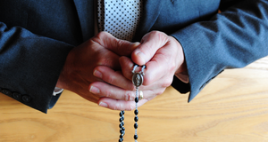 Man Praying Rosary.JPG