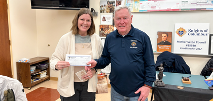 Grand Knight Gerry Enzmann of Mother Seton Council 15540 in Three Bridges, N.J., presents a $500 donation to Jen Halat, liaison for the Discalced Carmelite Nuns of Flemington. 