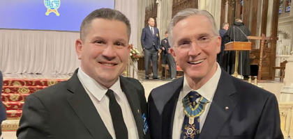 Grand Knight Salvator Laurenzano (left) of Msgr. Sherman Council 5103 in Glendale, N.Y., presents Supreme Knight Patrick Kelly with a model boxcar commemorating the 125th anniversary of the Fourth Degree.