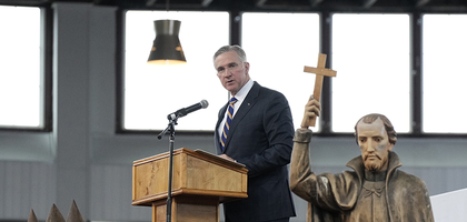 Supreme Knight Patrick Kelly speaks at the New York State Eucharistic Congress at Our Lady of Martyrs Shrine in Auriesville, N.Y., on Oct. 21, 2023. A statue of St. Isaac Jogues, one of three Jesuit missionaries martyred at the site in the 17th century, can be seen in the foreground.