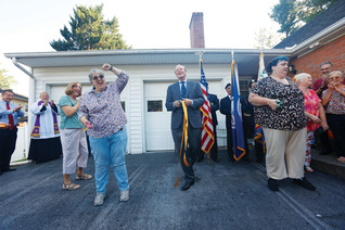 Residents of Marian Homes cut the ribbon at the opening of Our Lady of Guadalupe Home in Winchester, Va.