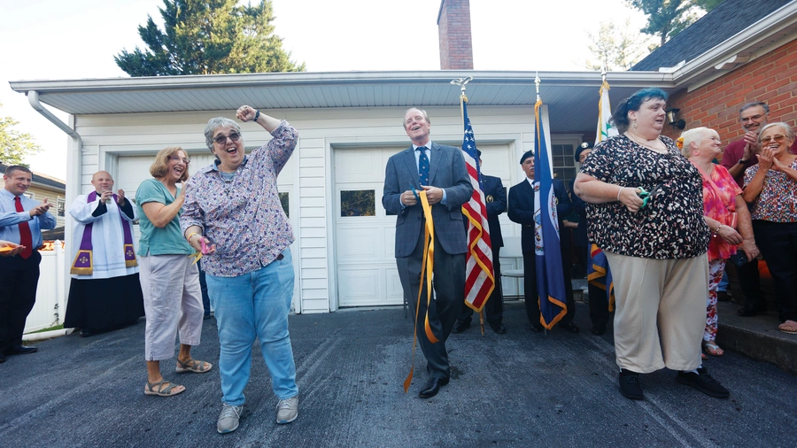 Residents of Marian Homes cut the ribbon at the opening of Our Lady of Guadalupe Home in Winchester, Va.