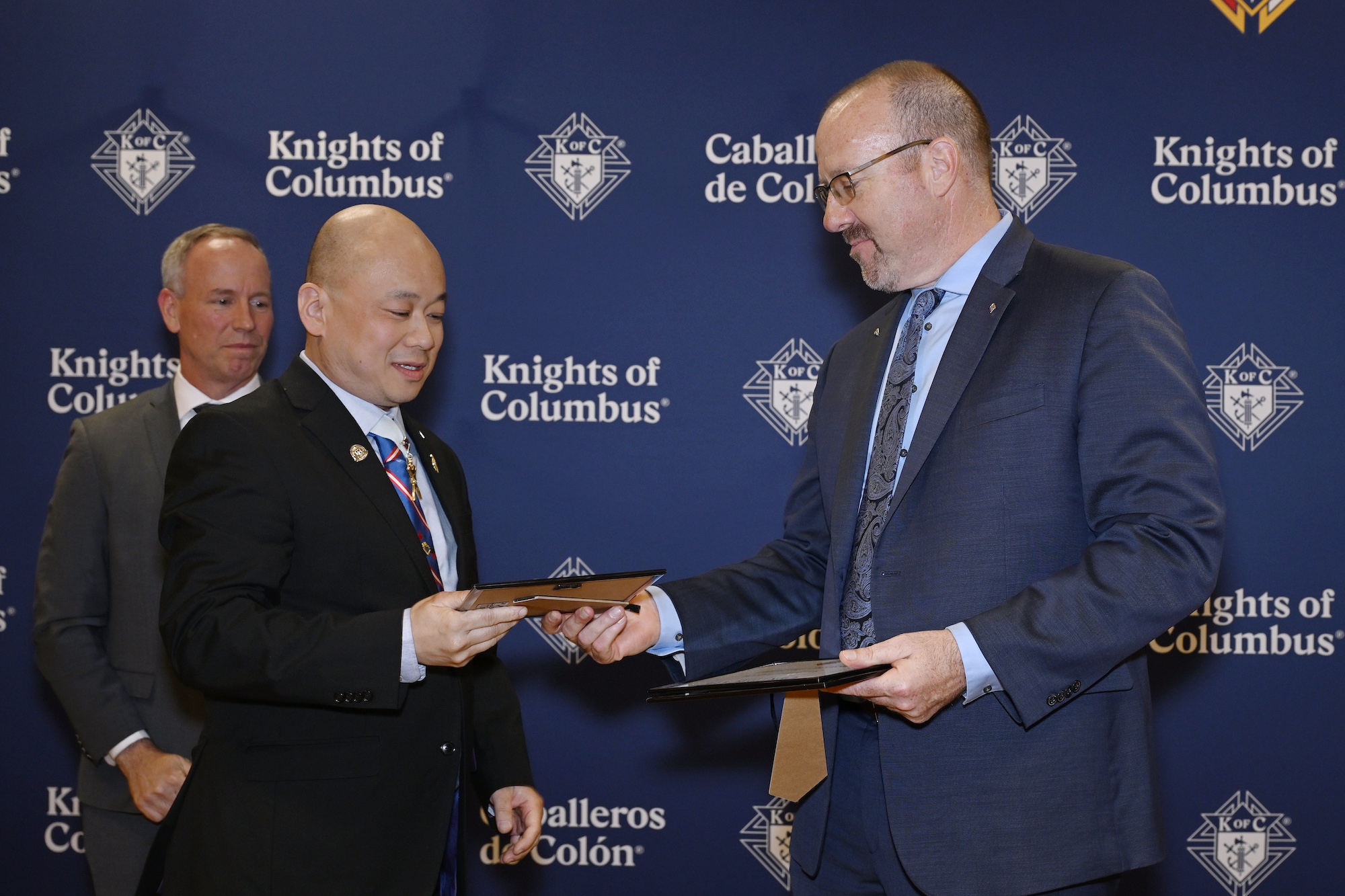 State Secretary Christopher Chen of British Columbia receives his certificate of completion for the McGivney Fellowship program 