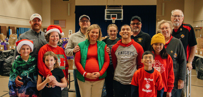 Knights and family members from Father Timothy P. Molony Council 2681 in Scottsbluff, Neb., are joined by State Deputy Bob Wolf (back right) for a Christmas distribution last year.