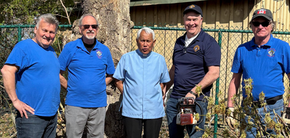 Members of Father Fenelon Council 10878 in Fenelon Falls, Ontario, stand with Father Luis Lapinid (center), pastor and council chaplain, after removing tree limbs and debris from the backyard at St. Aloysius Church’s rectory. 