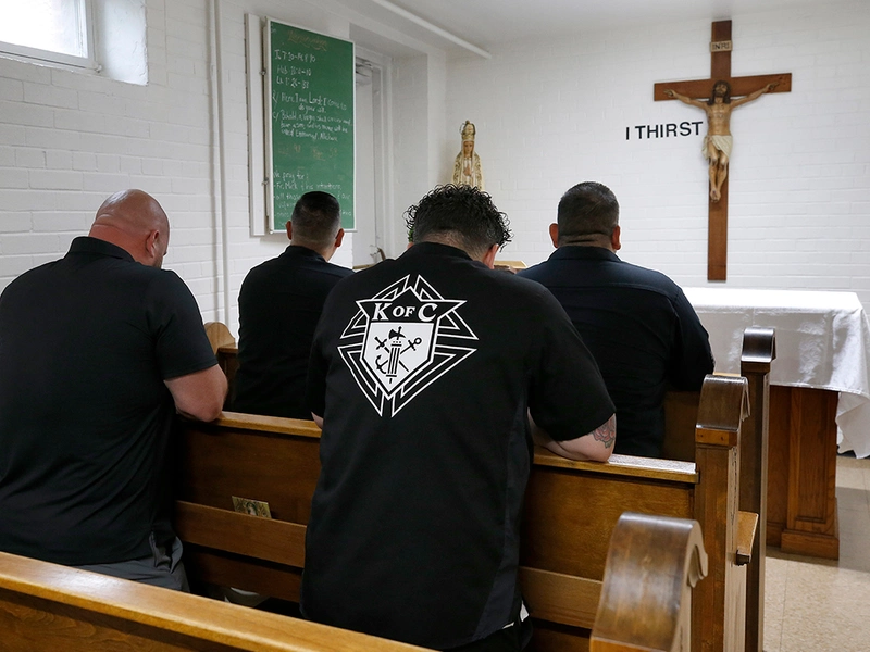 Members of St. Jude First Responder Council 17110 pray together in the chapel at St. Joseph&rsquo;s Home, a soup kitchen operated by the Missionaries of Charity in Chicago. (Photo by Karen Callaway)