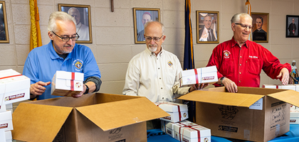 Members of St. Philip the Apostle Council 17028 pack some of the 250 Boxes of Joy collected from council members and parishioners of St. Philip the Apostle Parish in Lancaster, Pa., Nov. 7. (Photo by Michael Miville)