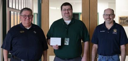 Grand Knight Dennis McEnearney (left) and Deputy Grand Knight Russ Sindelar (right) of St. Patrick Council 11296 in Council Bluffs, Iowa, present a $1,000 check to Principal Pat Ryan of St. Albert School. This was one of three $1,000 donations Council 11296 made to support special education programs at local schools.