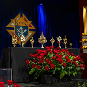First-class relics of numerous saints and blesseds, including Blessed Michael McGivney (right) and St. John Paul II (left), are displayed as the Memorial Mass of the 142nd Supreme Convention