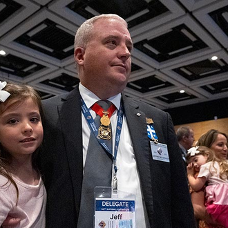 South Carolina State Deputy Jeffrey Crouch dressed in a black suit and his family attend the Memorial Mass of the 142nd Supreme Convention on Aug. 8 in Québec City.