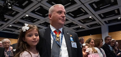 South Carolina State Deputy Jeffrey Crouch dressed in a black suit and his family attend the Memorial Mass of the 142nd Supreme Convention on Aug. 8 in Québec City.