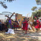 Francisco Sanchez Jauregui portrays Simon of Cyrene as he carries the cross during his council’s reenactment of the Stations of the Cross in 2025.
