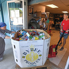Gordon Shellhaas and Servidora Sister Maria de Talpa Vargas Espinoza unload a food shipment at St. Michael Parish in Wauchula.