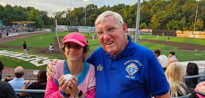 Past Grand Knight Bill Rudloff from Marquette Council 588 in Sparta, N.J., stands with a resident of a group home for people with disabilities operated by Catholic Charities Diocese of Paterson who is displaying the baseball from a ceremonial first pitch before a minor league baseball game at Skylands Stadium in Augusta. Council 588 has organized the outing for over 15 years, and this year, more than 120 residents of the diocese’s group homes attended the game.
