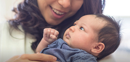 A mother holding her baby in her arms.
