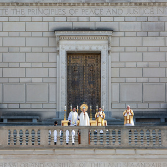 Bishop Andrew Cozzens of Crookston, Minnesota, raises the monstrance in benediction outside the Indiana War Memorial.