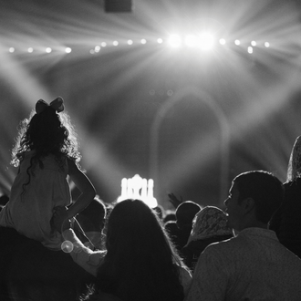 A family participates in Eucharistic adoration July 20 at Lucas Oil Stadium during the National Eucharistic Congress in Indianapolis.