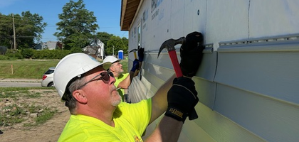 Deacon Rob Lortie of Father Thomas A. Brandon Council 451 in Fort Wayne, Ind., nails siding into a new home during a Habitat for Humanity build. Knights from Council 451 have helped build 10 homes with Habitat since June 2019.