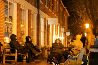 Knights gather on benches along Main Street in Nantucket, Mass.
