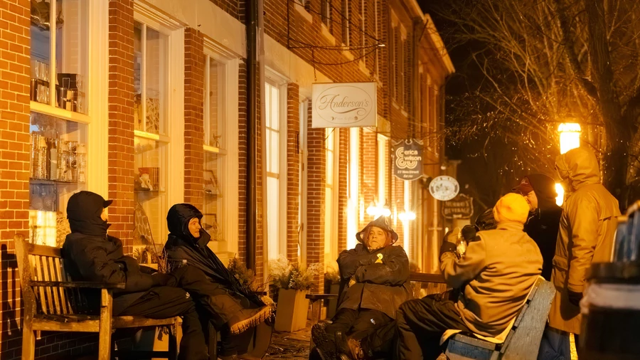 Knights gather on benches along Main Street in Nantucket, Mass.