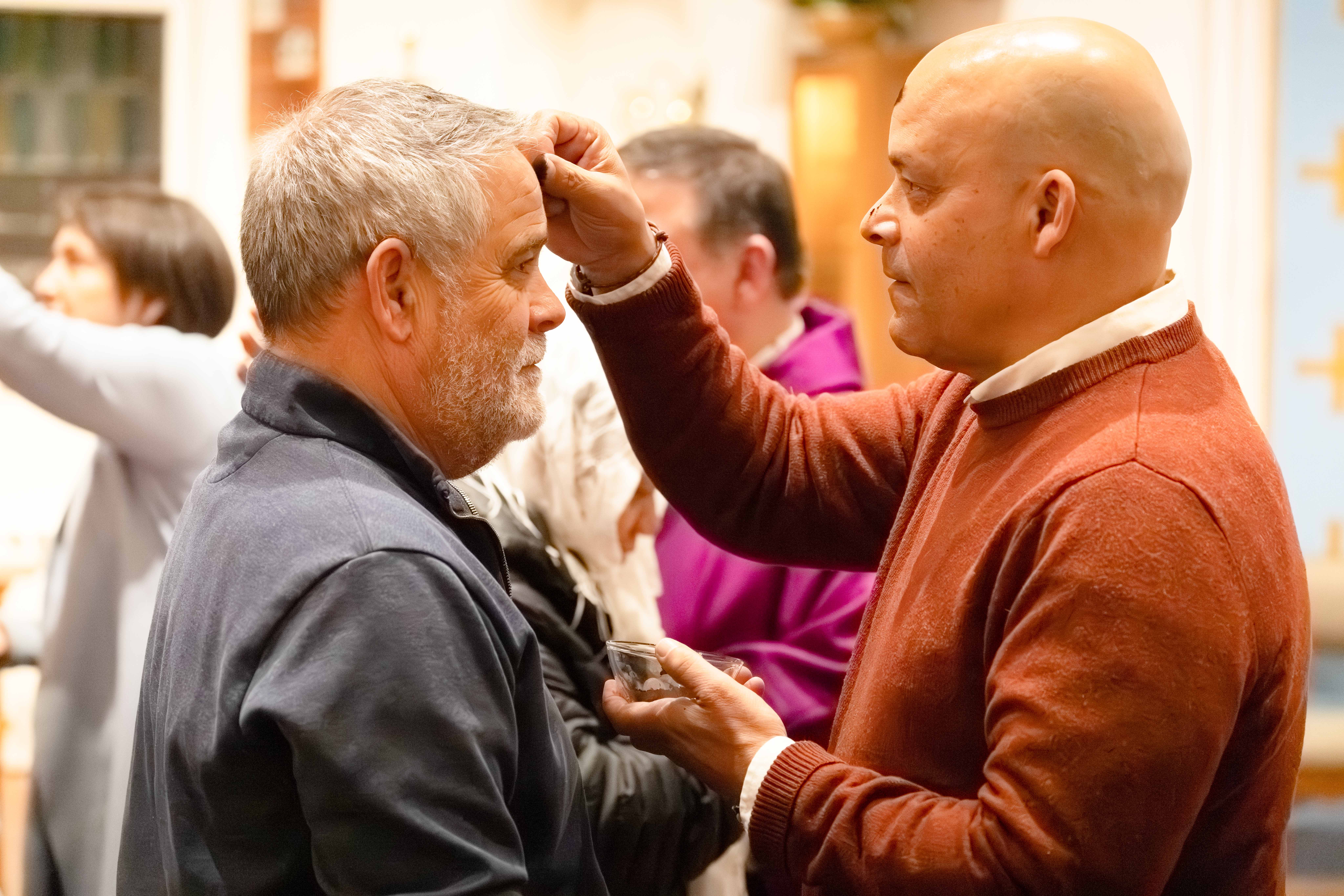 A Knights receives ashes in Nantucket, Mass., before spending the night outside during the council's homelessness awareness fundraiser.