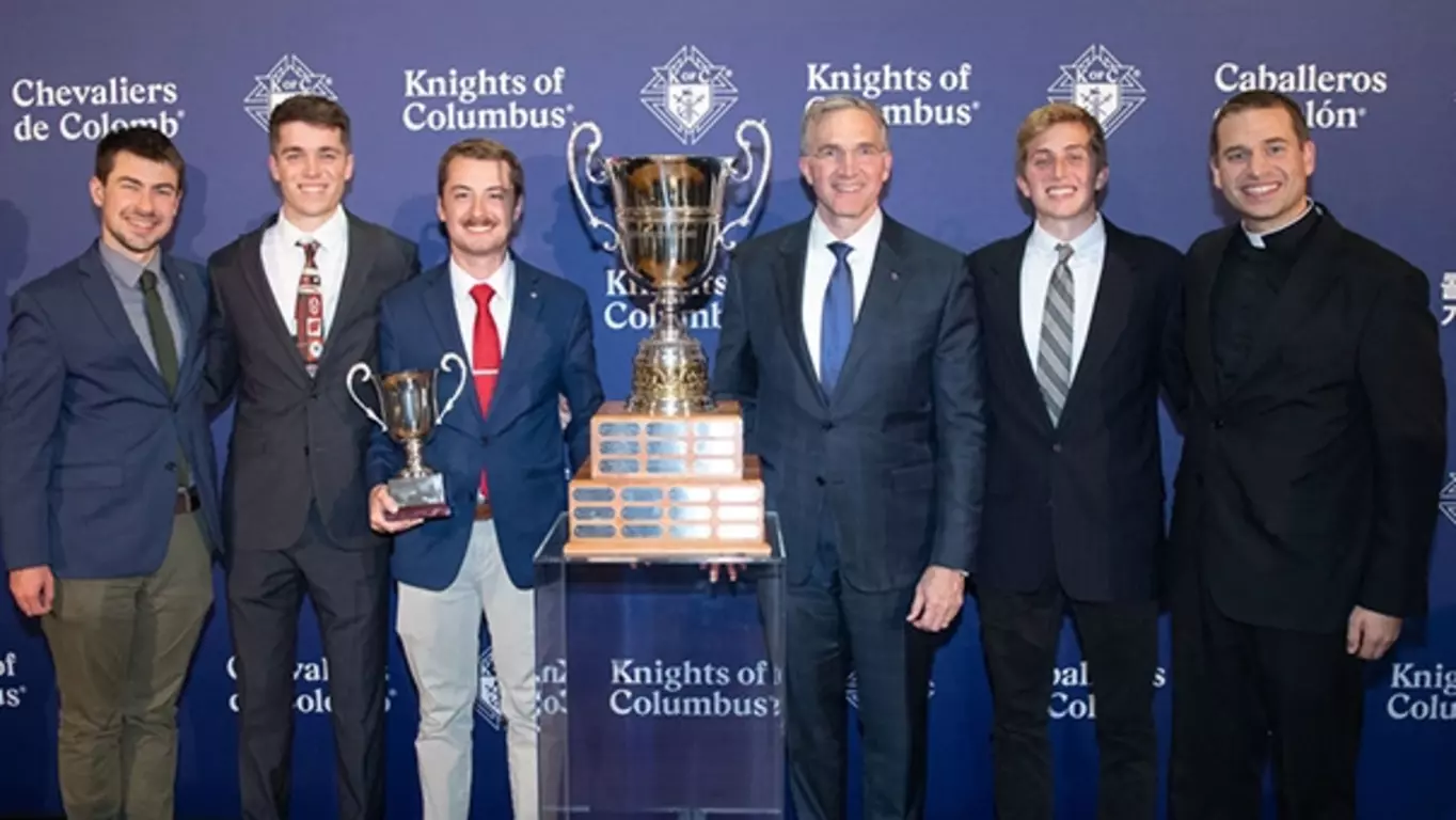 Recipients of the Outstanding College Council Award stand with Supreme Knight Patrick Kelly and their trophy.