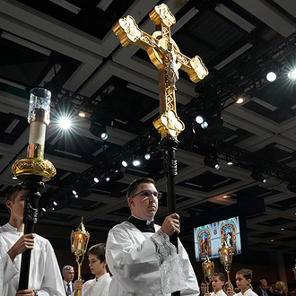 Acolytes process into the opening Mass of the 142nd Supreme Convention at the Québec Convention Center in Québec City on Aug. 6.