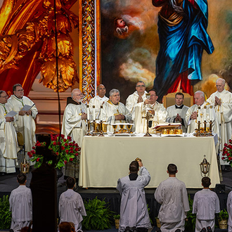 Cardinal Gérald Lacroix elevates the chalice during the Liturgy of the Eucharist during the opening Mass of the 142nd Supreme Convention in Québec City on Aug. 6.