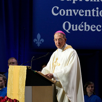 Archbishop William Lori of Baltimore, supreme chaplain of the Knights of Columbus, reads the papal greeting to the 142nd Supreme Convention from Vatican Secretary of State Cardinal Pietro Parolin at the conclusion of the opening Mass in Québec City on Aug. 6.