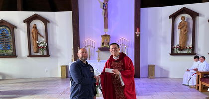 Grand Knight Scott Motsinger of Tillamook (Ore.) Council 2171 presents a $10,000 check to Father Angelo Te, pastor of Sacred Heart Church and a brother Knight, to offset the costs of a new ceiling and windows for the parish hall. The funds came from Council 2171’s annual sausage dinner, held for over 60 years.