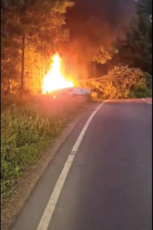 The scene of the accident after Adam Parzuchowski pulled the driver to safety and the truck burst into flames.