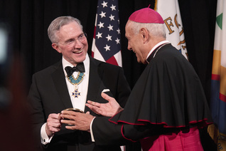 Supreme Knight Patrick Kelly accepts the Path to Peace Award.