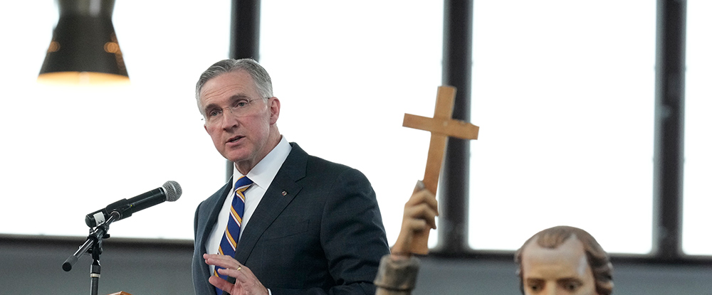 Supreme Knight Patrick Kelly speaks at the New York State Eucharistic Congress at Our Lady of Martyrs Shrine in Auriesville, N.Y., on Oct. 21, 2023. A statue of St. Isaac Jogues, one of three Jesuit missionaries martyred at the site in the 17th century, can be seen in the foreground.